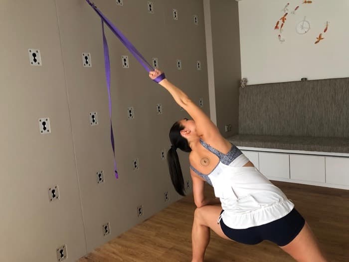 Wall rope yoga using the ropes for supported traction